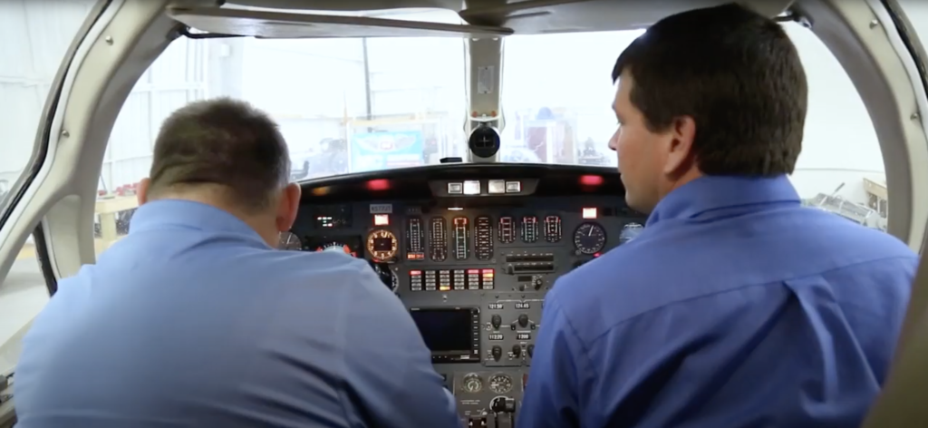 A&P instructors in jet cockpit with instrument panel